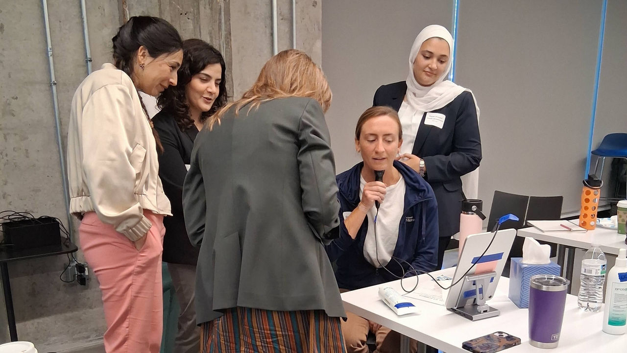 Professionals who attended the Ultra-SLP conference use an ultrasound machine 