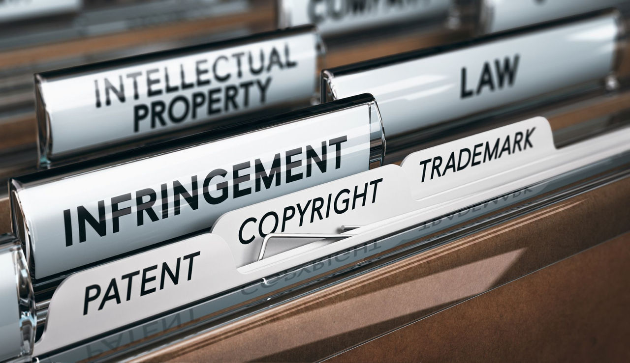 Shows filing cabinet is folders saying: intellectual property, infringement, patent, copyright and trademark