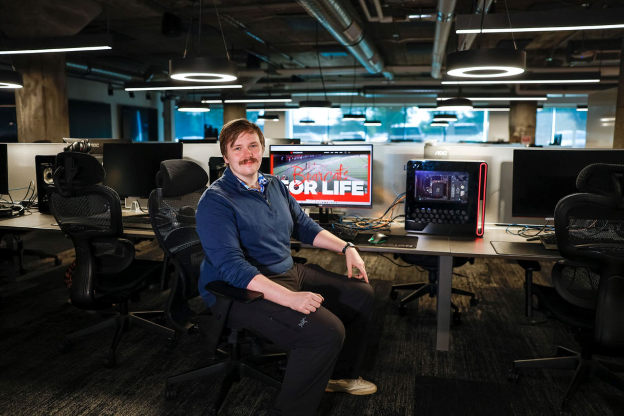 Ethan Bernhardt seat at a computer in the UC E-Sports Innovation Lab