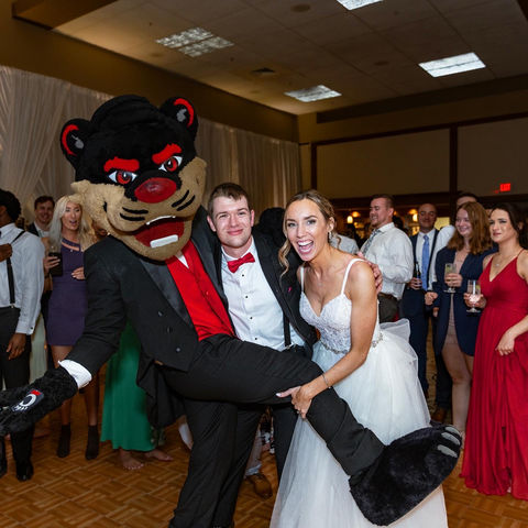 UC Mascot and couple at wedding
