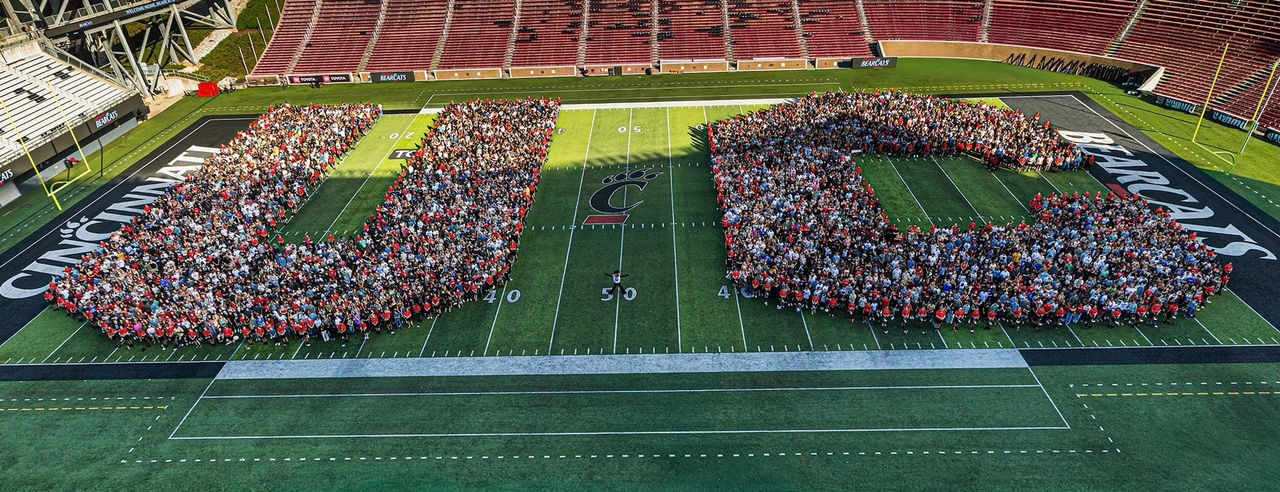 UC's record first-year class gathers in the shape of a U and C on Nippert Stadium field.