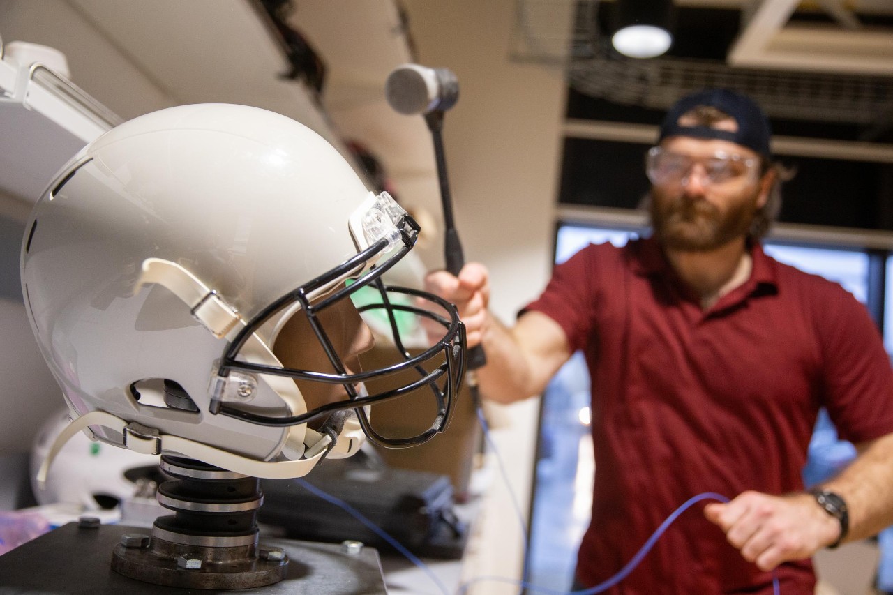 Led by Dr. Eric Nauman, a professor of biomedical engineering in UC’s College of Engineering and Applied Science, University of Cincinnati engineers put popular football helmets made by leading brands through impact testing and found that no single design demonstrated superior reduction of potential concussion incidence or consistent energy absorption at every part of the helmet. Research assistants: Sean Bucherl (ball cap), Christopher Boles (UC sweatshirt), and Shengming Hu (UC polo).