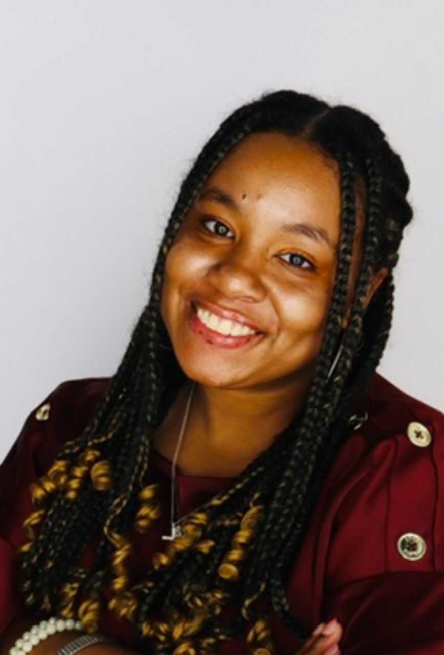 Headshot of woman against grey background