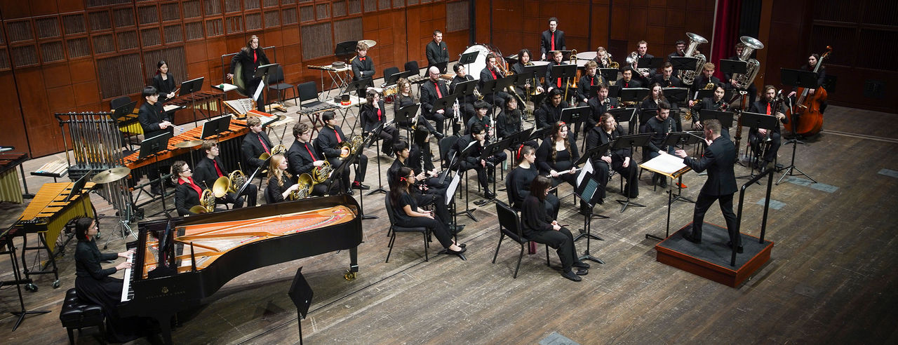 CCM Wind Symphony performs on stage.