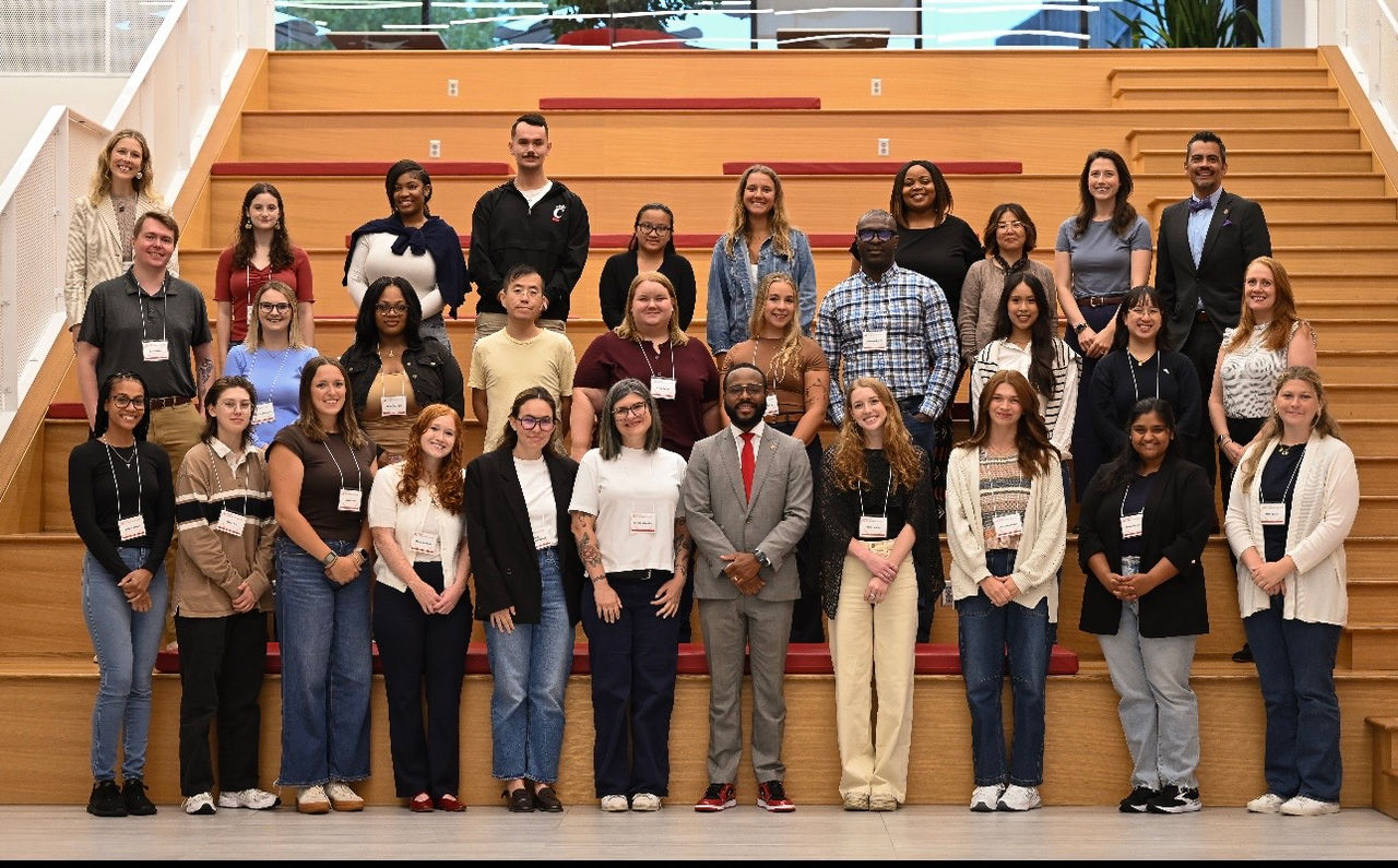 GENESIS cohort pose for photo on the law school's social stairs