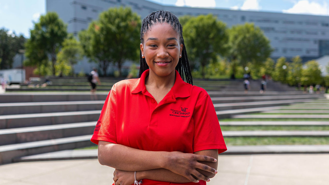 Woman standing in front of campus building
