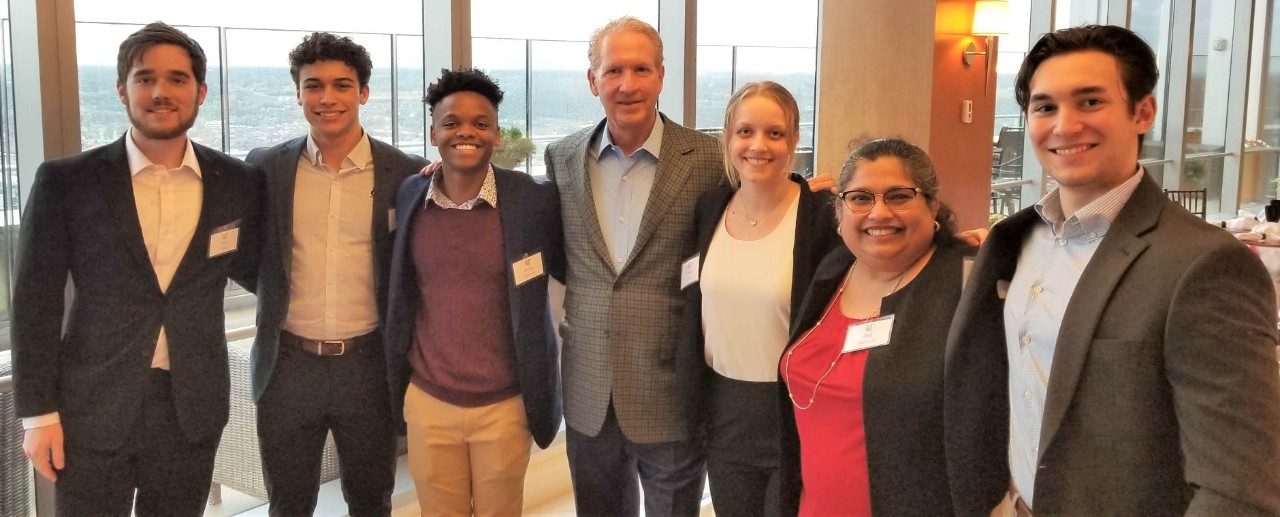 Students and a business executive in professional dress