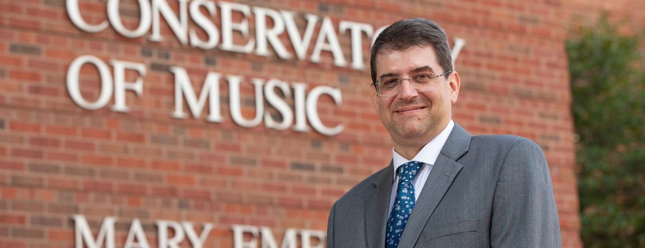 A portrait of CCM Dean Pete Jutras in front of Mary Emery Hall.