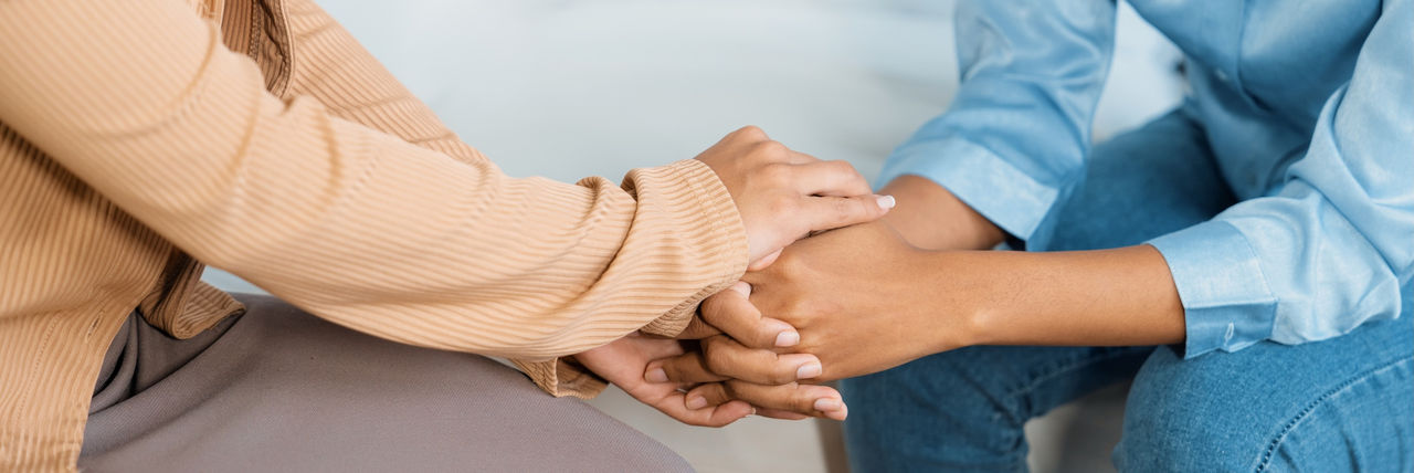 Supportive and comforting hands clasped in empathy