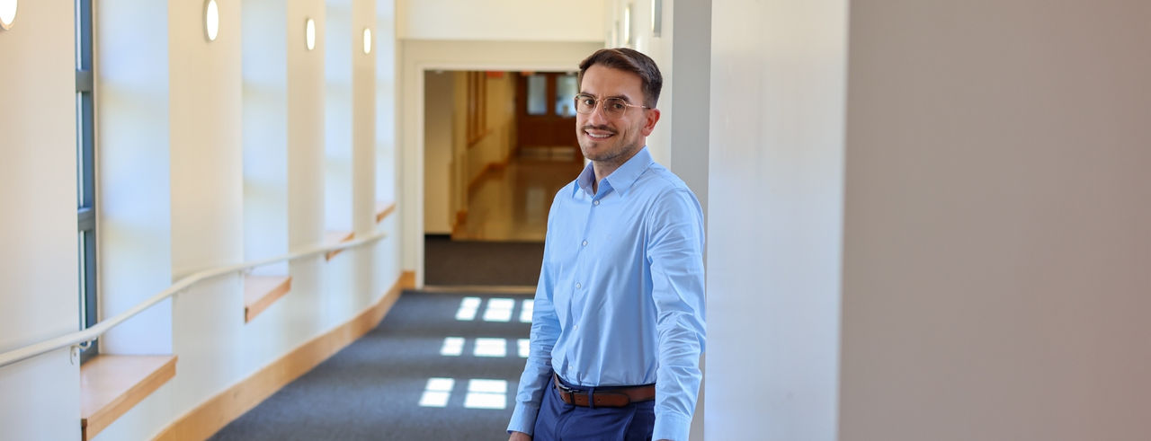 Tommaso Giovannelli stands in the hallway in UC's Mantei Center