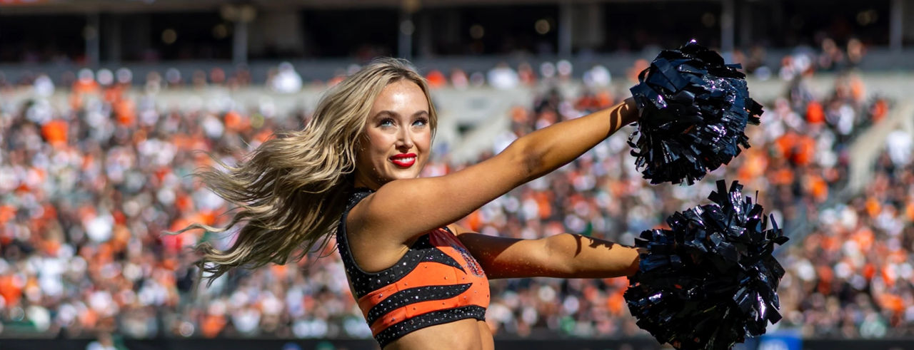 Bengals cheerleader holding pom-poms