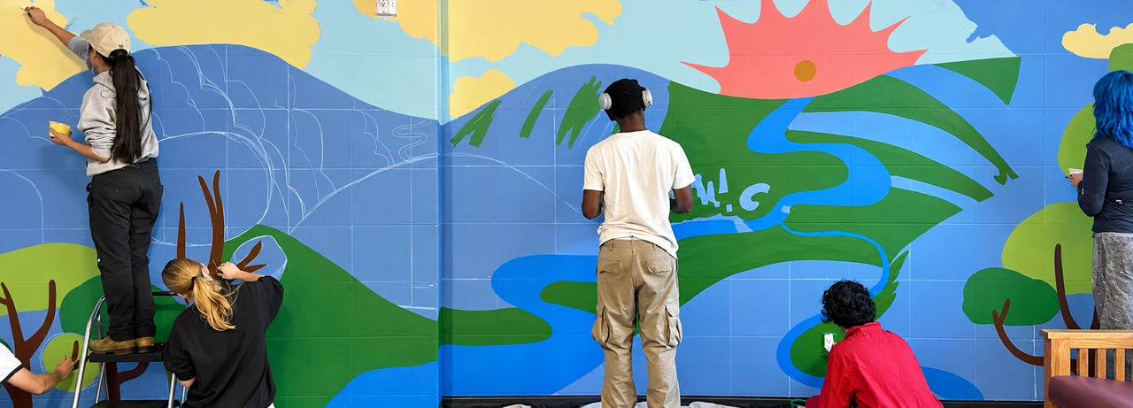 DAAP students paint a wall as part of the MATCH program. 