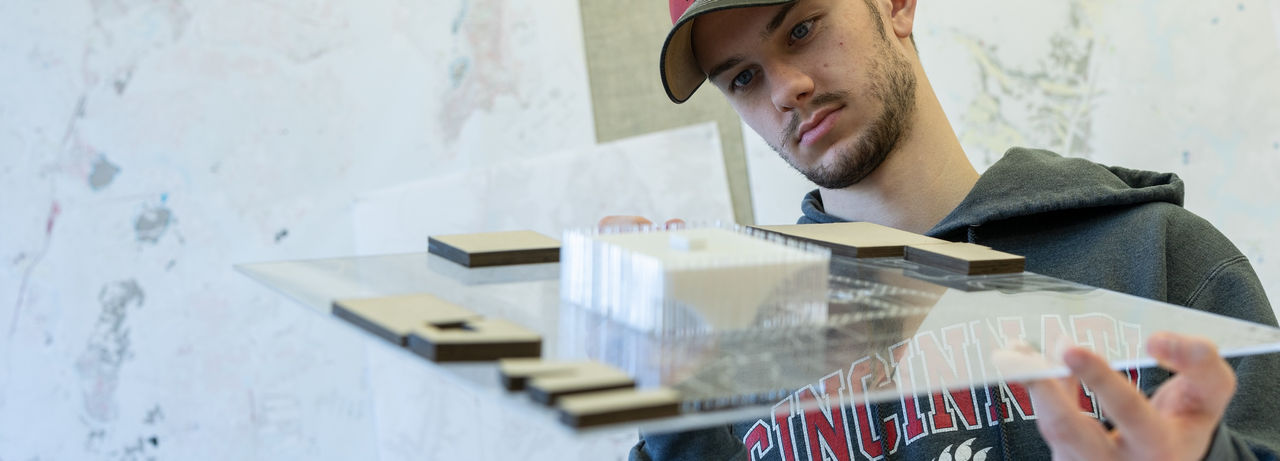 DAAP student holding a urban plan model
