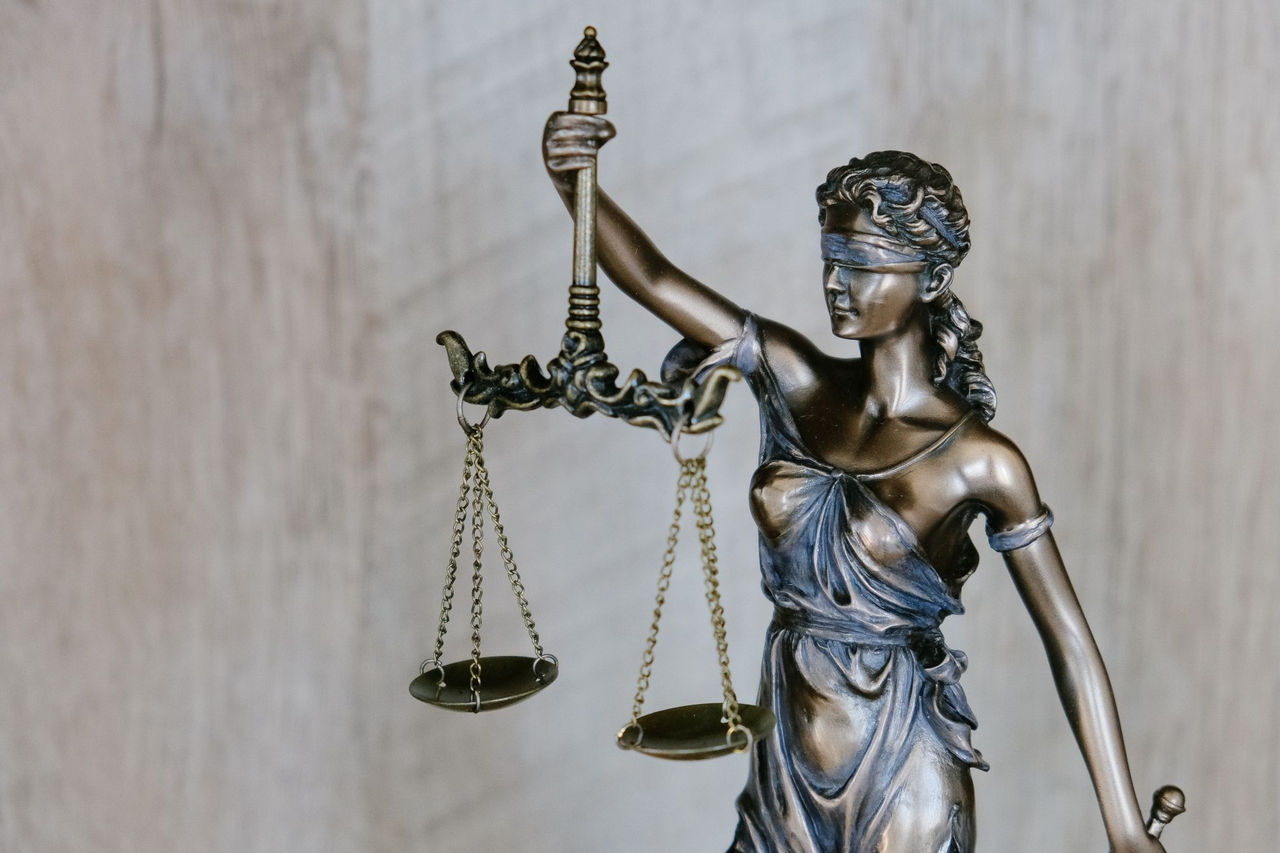 Image of a the goddess of justice holding scales
