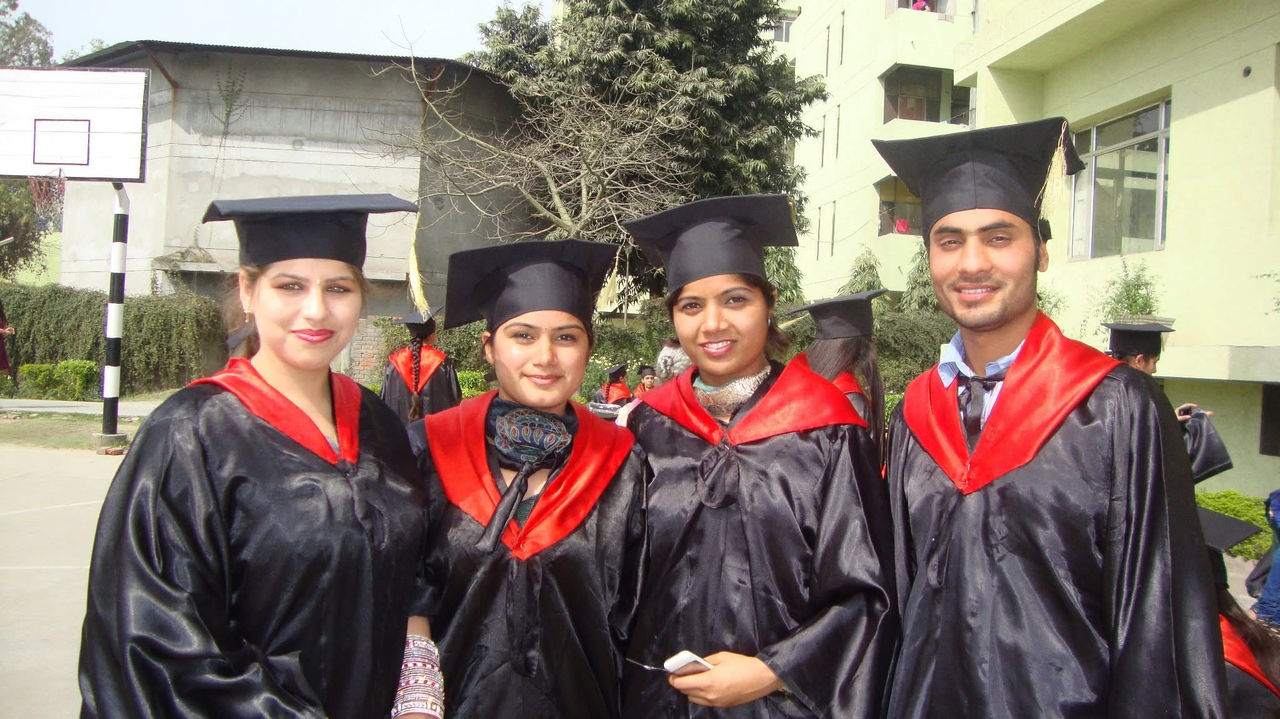 Harman Sivia between classmates at her graduation in India