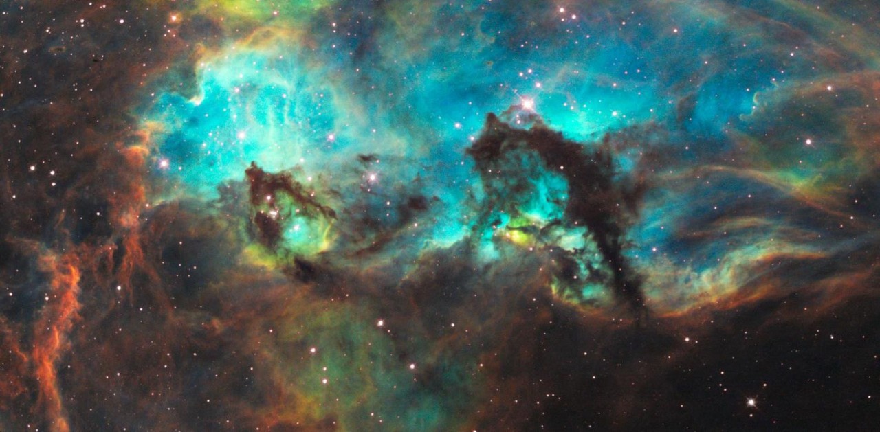A swirl of clouds and and colors in a distant nebula captured by a space telescope.