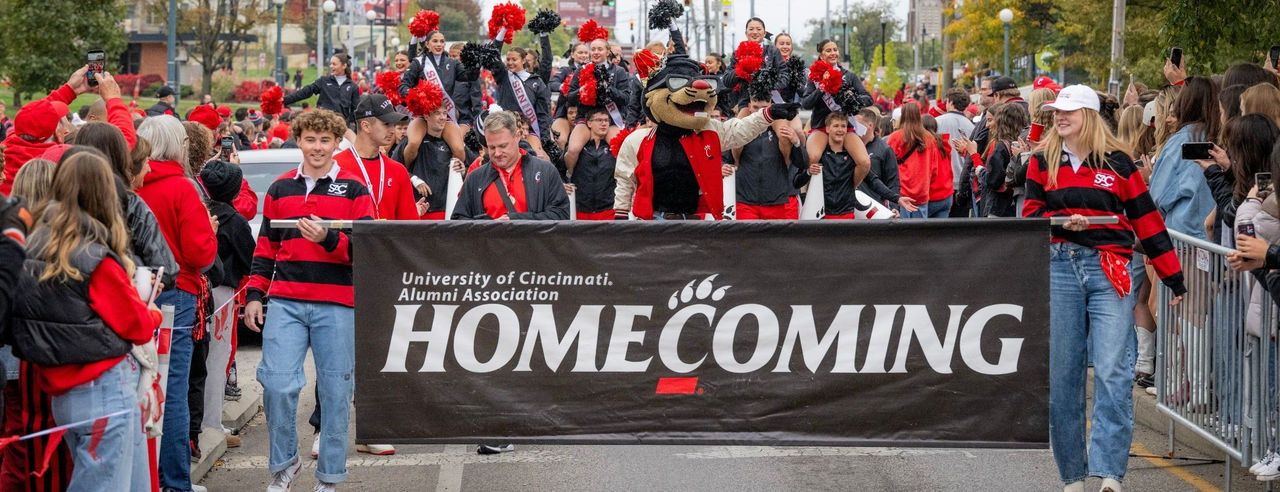 Student Alumni Council members carrying the leading banner in the 2025 Homecoming Parade.