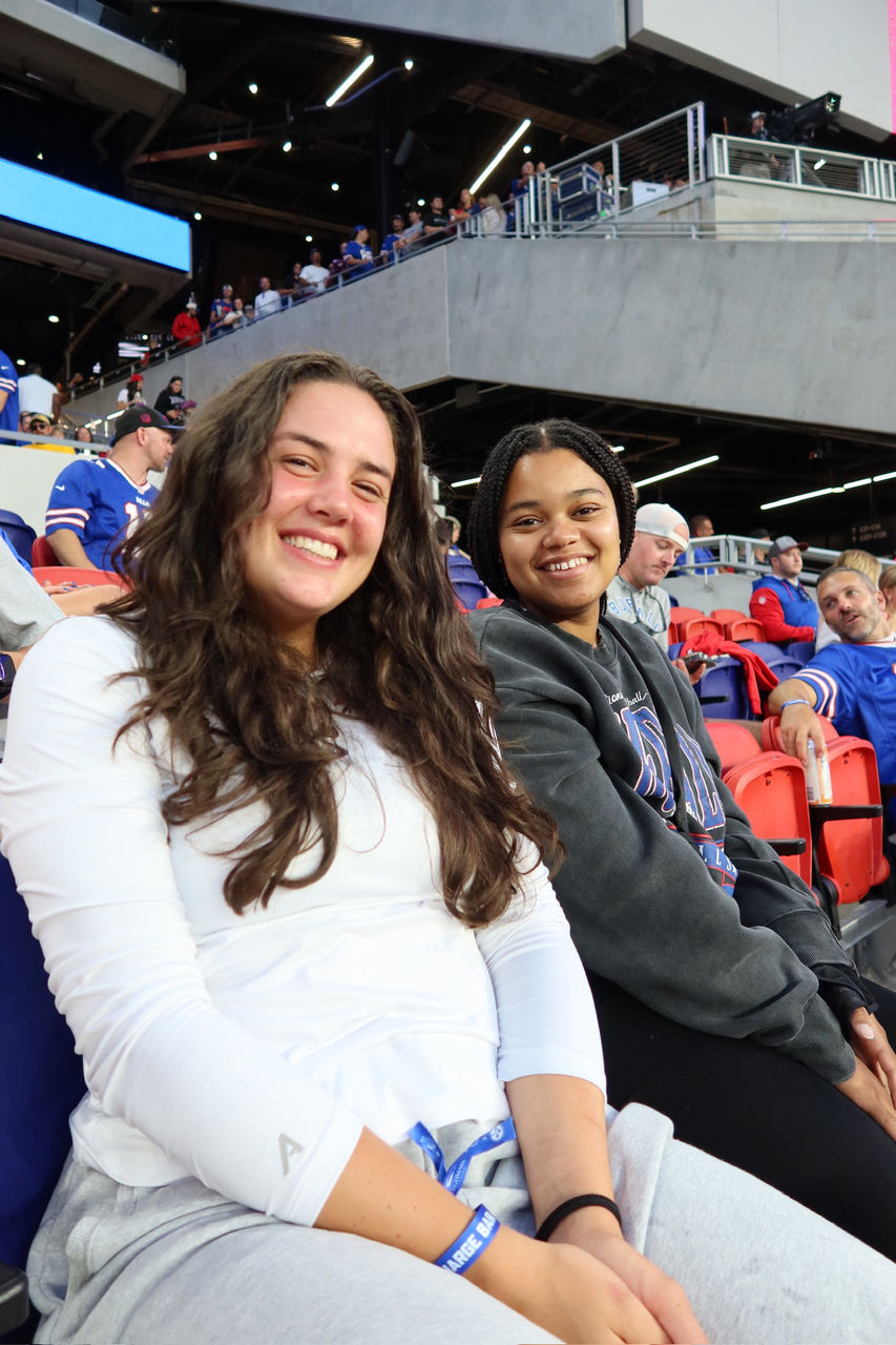 Savannah Posey and another person seated in the stands at the new Highmark Stadium 