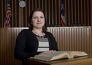 This is a photo of UC anthropology researcher Leila Rodriguez in the mock courtroom in UC's College of Law.