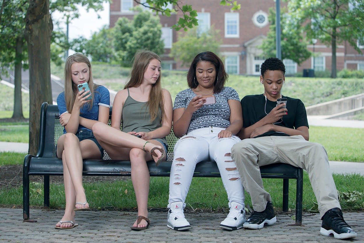 Girls and boys who represent Generation Z gather on campus.