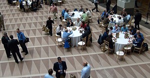 professionals at a conference, eating and talking 