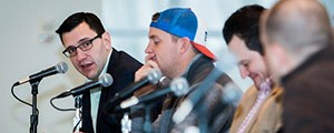 Panelists speak at microphones at a past UC Social Media Week Summit