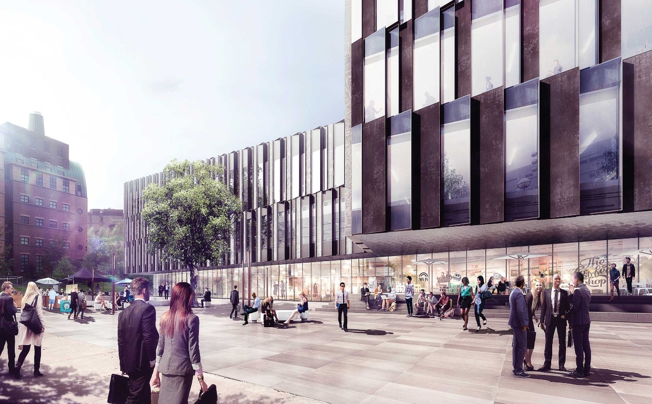 A daytime exterior view of the new business building with people entering out front.