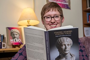 Lauren Ginsberg holding a copy of her book