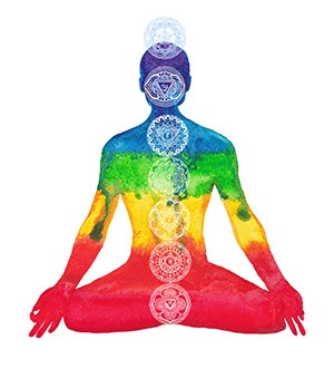 Silhouette of a person in yoga pose with chakra regions highlighted in different colors on his spine. 