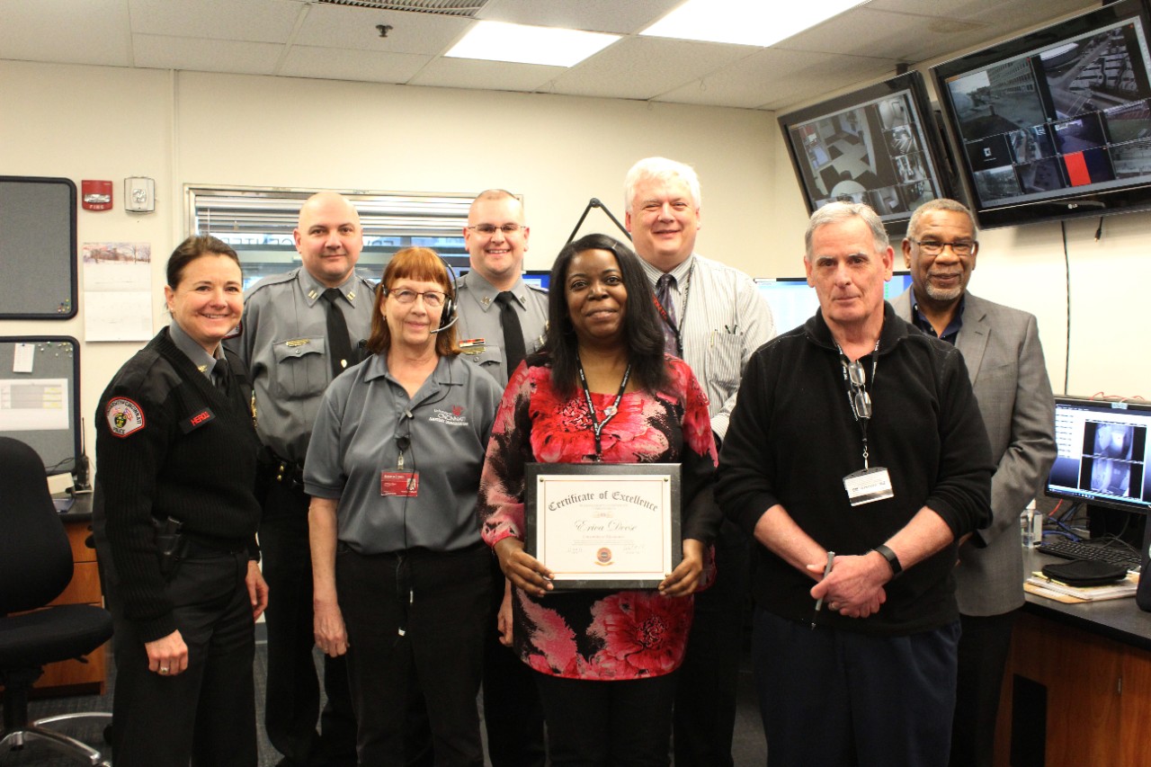 Erica Deese, one of UC's Emergency Communications Dispatchers, stands with members of the Public Safety Department.