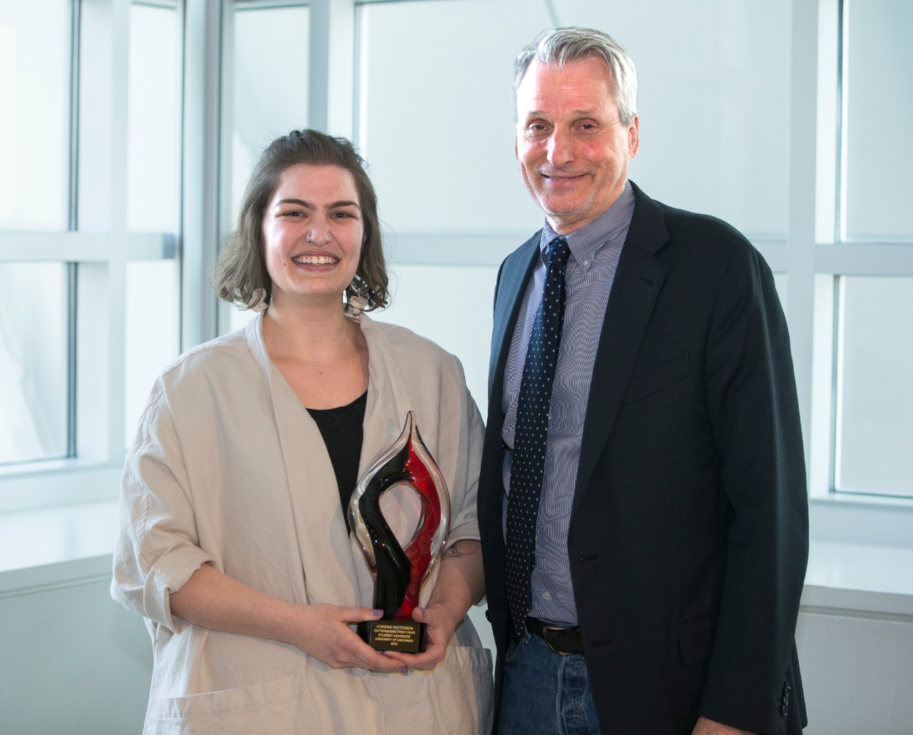 Patterson and Imbrie stand with award