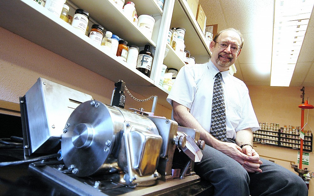 Randy Wickett, PhD, sits by a 3-roll mill which disperses pigments in color cosmetics.