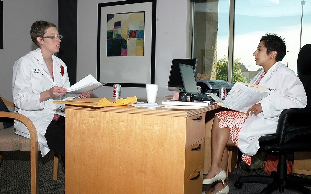 Jennifer Manders, MD, and Anureet Bajaj, MD, discuss a patient case. The duo launched an oncoplastic surgery clinic at University Pointe in August 2006.