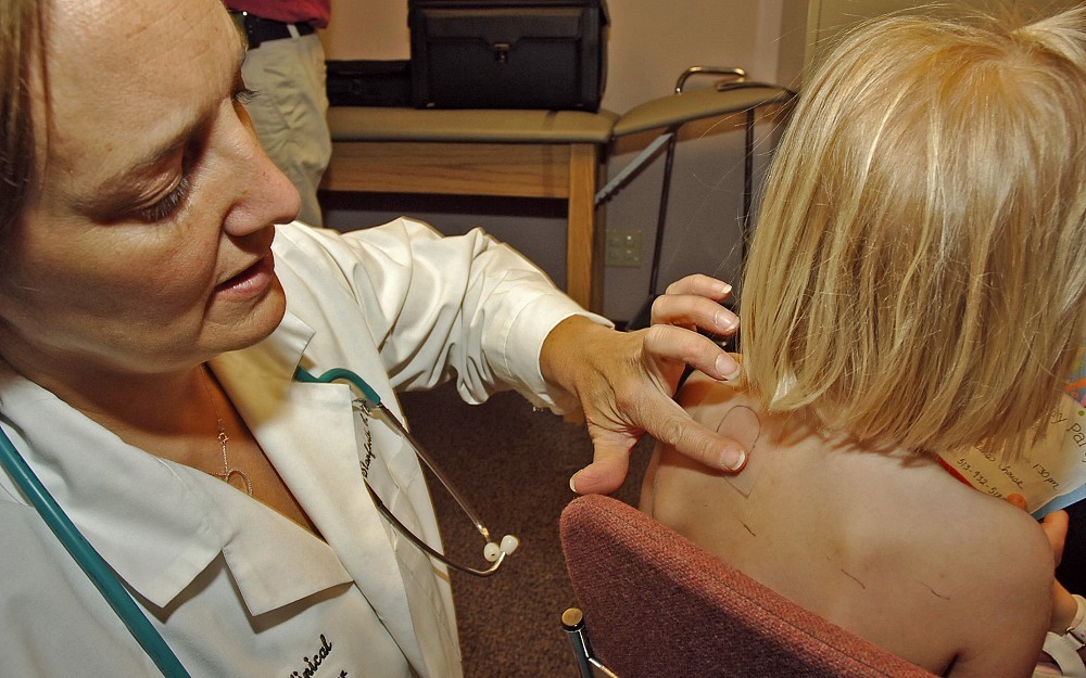 Nurse practitioner Sherry Stanforth evaluates a child's allergic reactions to a skin prick test as part of the Cincinnati Childhood Allergy and Air Pollution Study at the University of Cincinnati. 