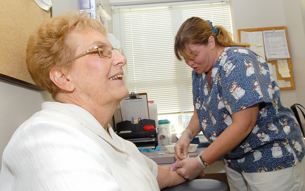 Teresa Ramirez (right) draws Edwa Yocum's blood as part of the Fernald Medical Monitoring Program. 