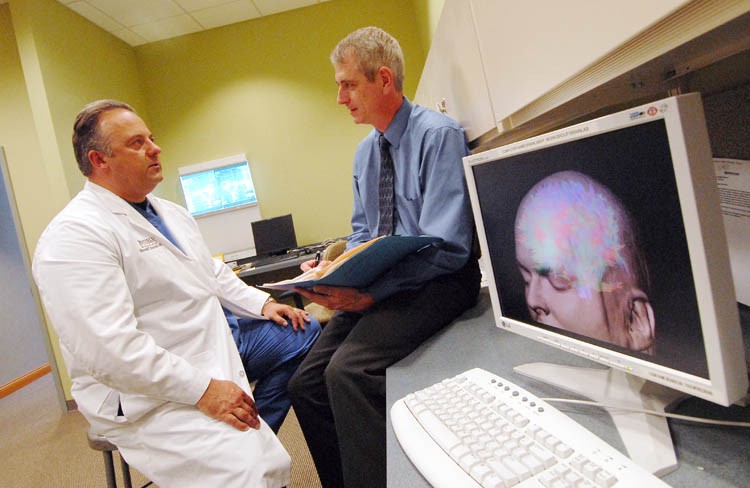 Ronald Warnick, MD, and Jon Breneman, MD, discuss a patient's case. 