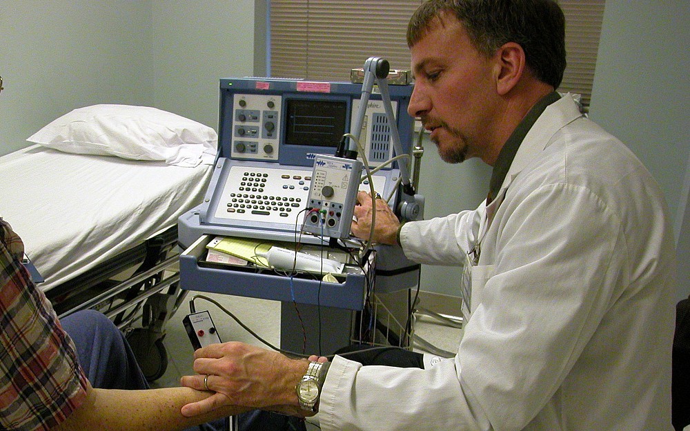 Mark Goddard, MD, administers an EMG test. 