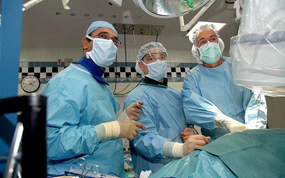 Krishnanath Gaitonde, MD, (left) and colleagues in the operating room. 