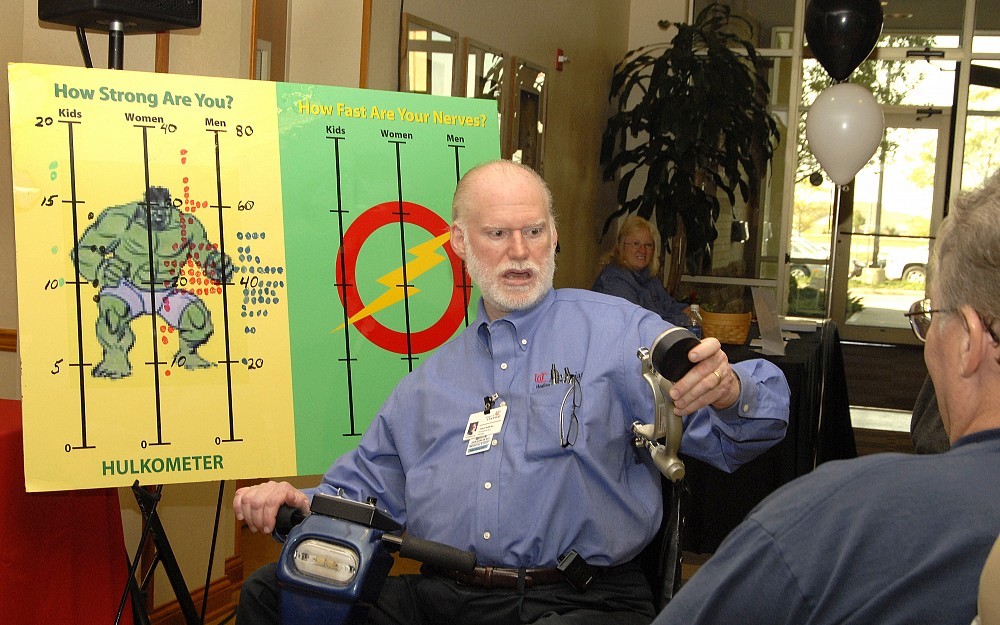John Quinlan, MD, checks out the results of a strength test at the 2007 UC Physicians group Health and Wellness Fair.