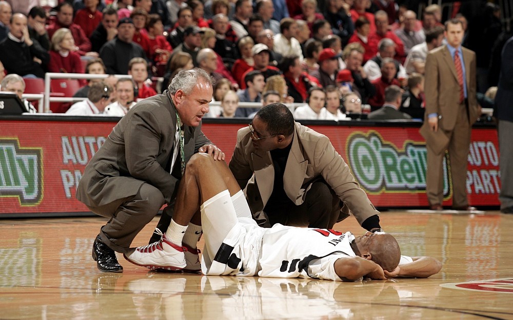 Angelo Colosimo, MD, examines an injured UC Bearcats player.