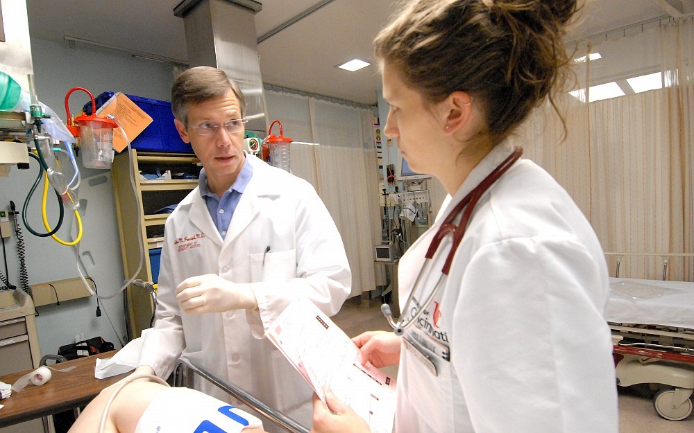 Arthur Pancioli, MD, Richard C. Levy chair for emergency medicine, instructs third-year medical student Kourtni Starkey in the emergency department at University Hospital. 