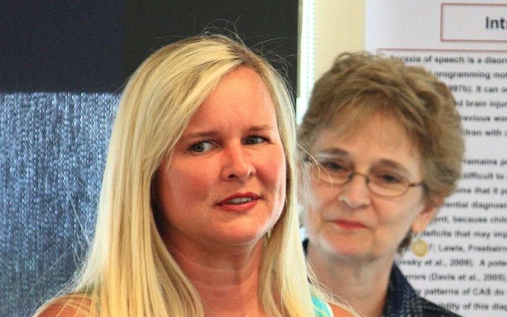 Tonia Jones (left, front) graduates from the LEND program in June 2011 as director Karen Edwards looks on. 