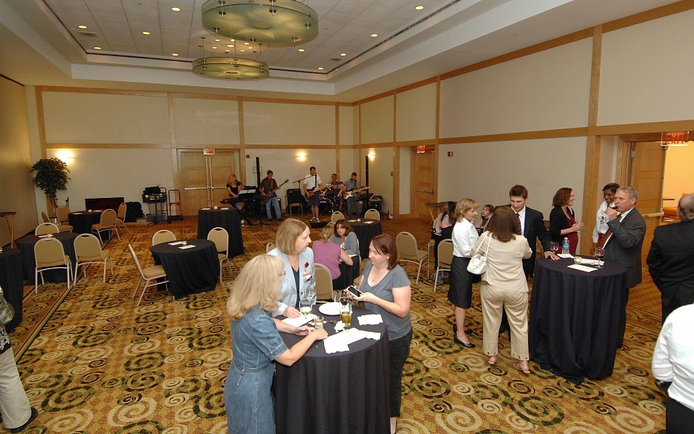 Attendees enjoy the UC Health Clinical Trials Office one-year anniversary event as Some Assembly Required, with Stephen Strakowski, MD, on bass, plays in the background.
