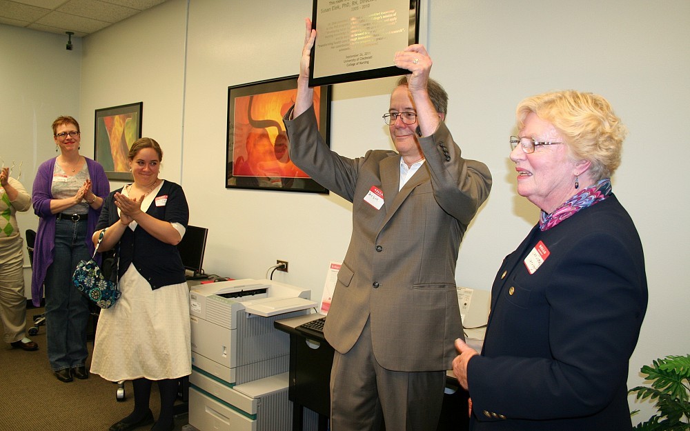 David Shore, MD, (center) accepting the plaque from Janice Dyehouse, PhD (right). Susan ElekÂ s daughter, Abby Shore, is pictured center left.