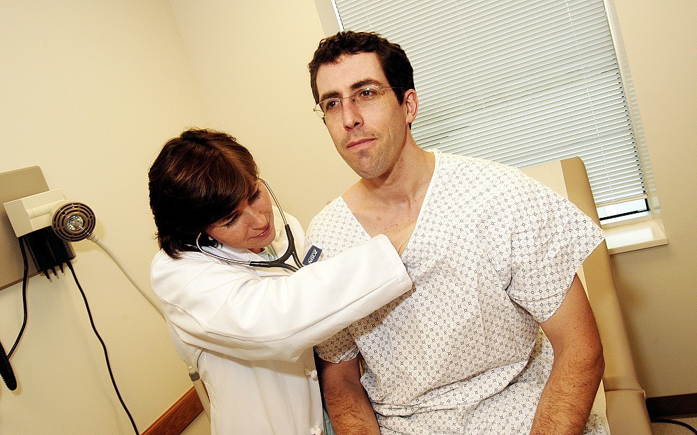 Resident Lee Ann Merchen, MD, examines Christopher Duncan.