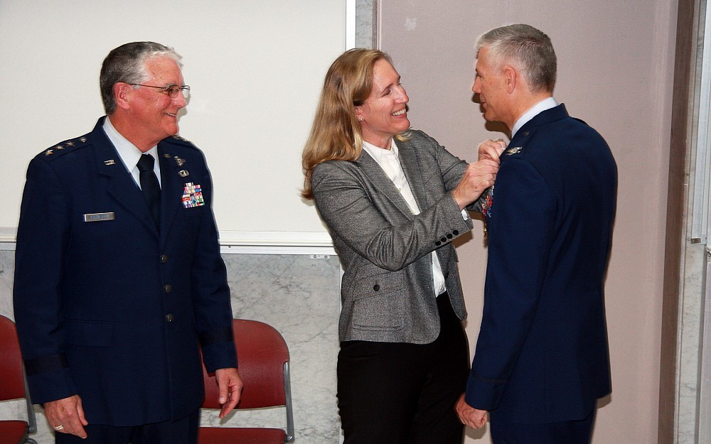 UC critical care and pulmonary physician Col. Gina Dorlac, MD, pins an Air Force retirement pin onto her husband and UC trauma surgeon Col. Warren Dorlac, MD.