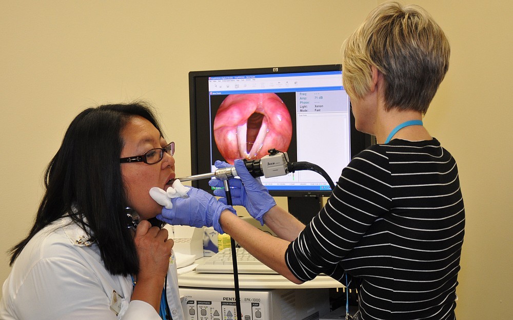 Speech pathologist Eva van Leer, PhD, conducts an exam on a World Choir Games participant.