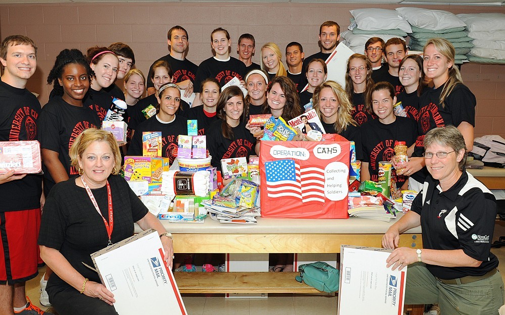 Volunteers from the College of Allied Health Sciences assemble military care packages. 