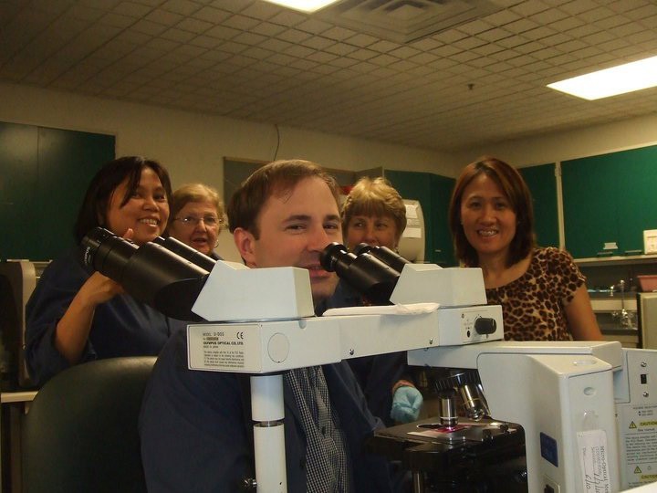 Aaron Domine with colleagues in Troy, New York. Domine will graduate from UC's MLS distance learning program during Winter Commencement Saturday, Dec. 15, 2012.