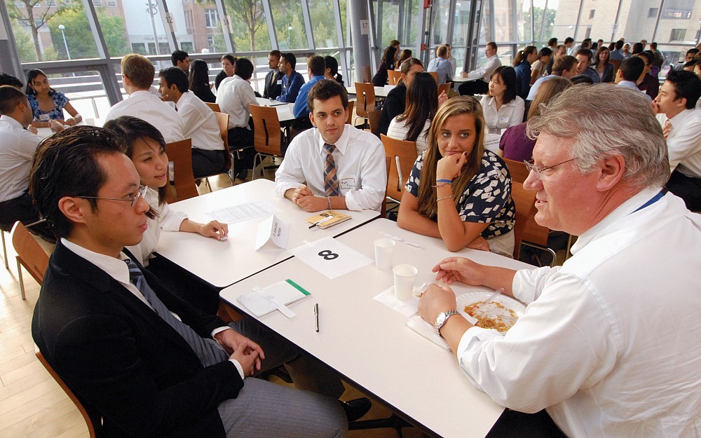 First-year medical students (from left to right) Joseph Song, Joanna Jeong, Matthew Fanous and Meghan Brown talk with James Curell, MD (right), an associate professor of psychiatry, during a medical specialty event held in September. 